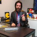 Billy Mitchell sits in his office at Metro Wrapz, in Hollywood, Florida, where he is developing custom arcade game covers.